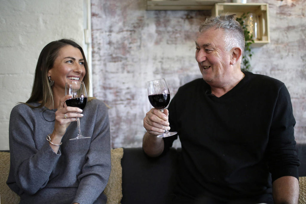 In this May 17 photo, Peter Peacock and Gypsy Diamond share a laugh over a glass of Shiraz each, their favorite type of wine, in Melbourne, Australia. (AP Photo/Wong Maye-E)
