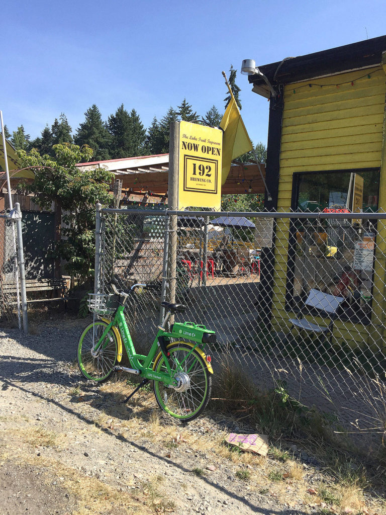 A rental bike is parked in front of Kenmore’s 192 Brewing Co. along the Burke-Gilman Trail. (Aaron Swaney)
