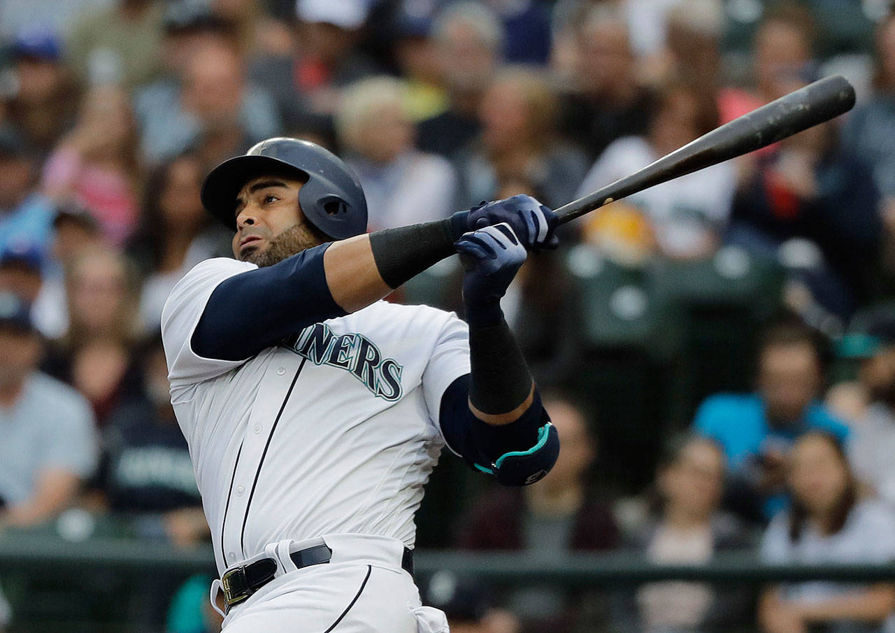 Seattle’s Nelson Cruz watches his two-run home run during the first inning of Thursday’s game at Safeco Field. (AP Photo/Ted S. Warren)