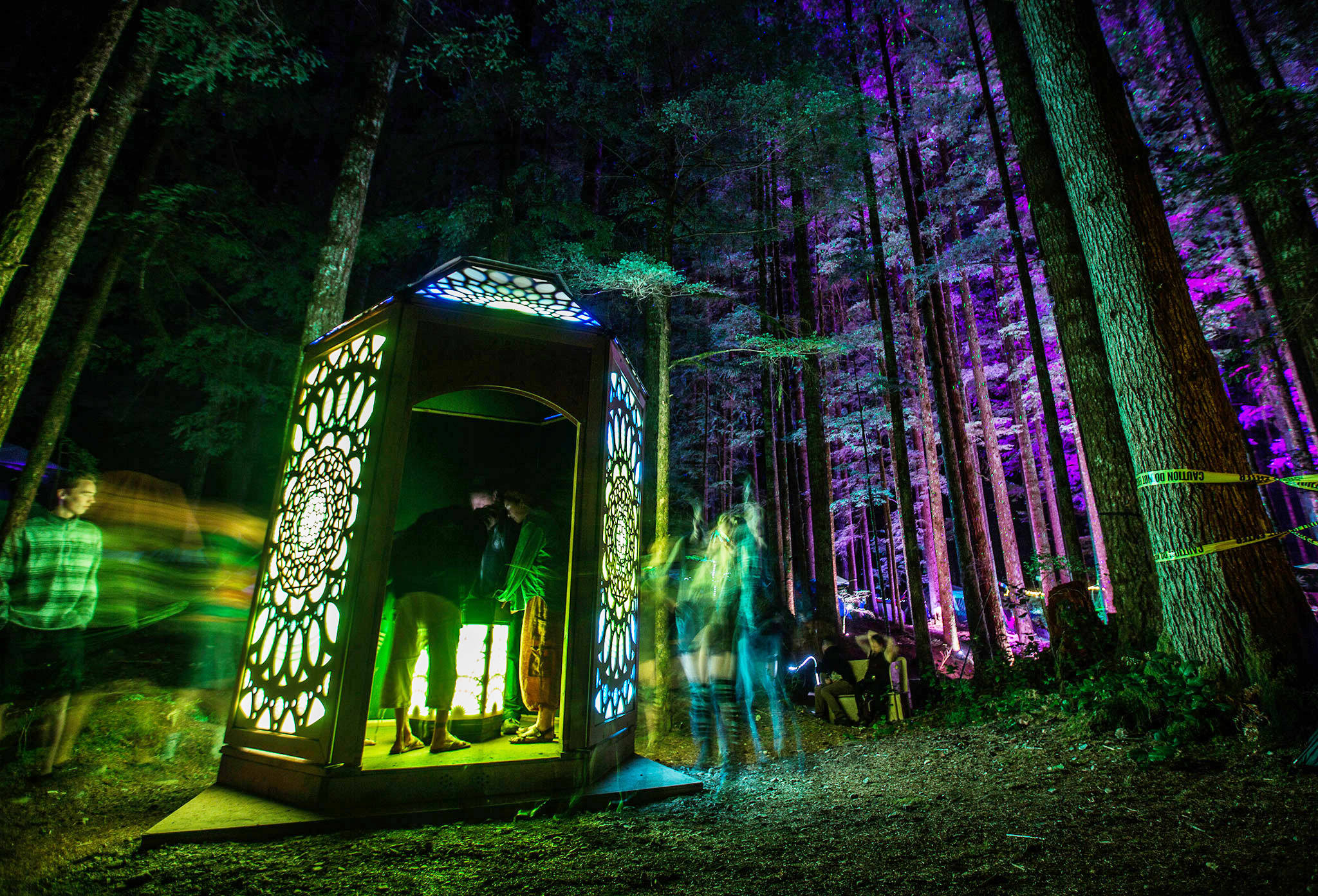 People explore the Axis Mundi art installation at the Summer Meltdown on Thursday in Darrington. (Olivia Vanni / The Herald)