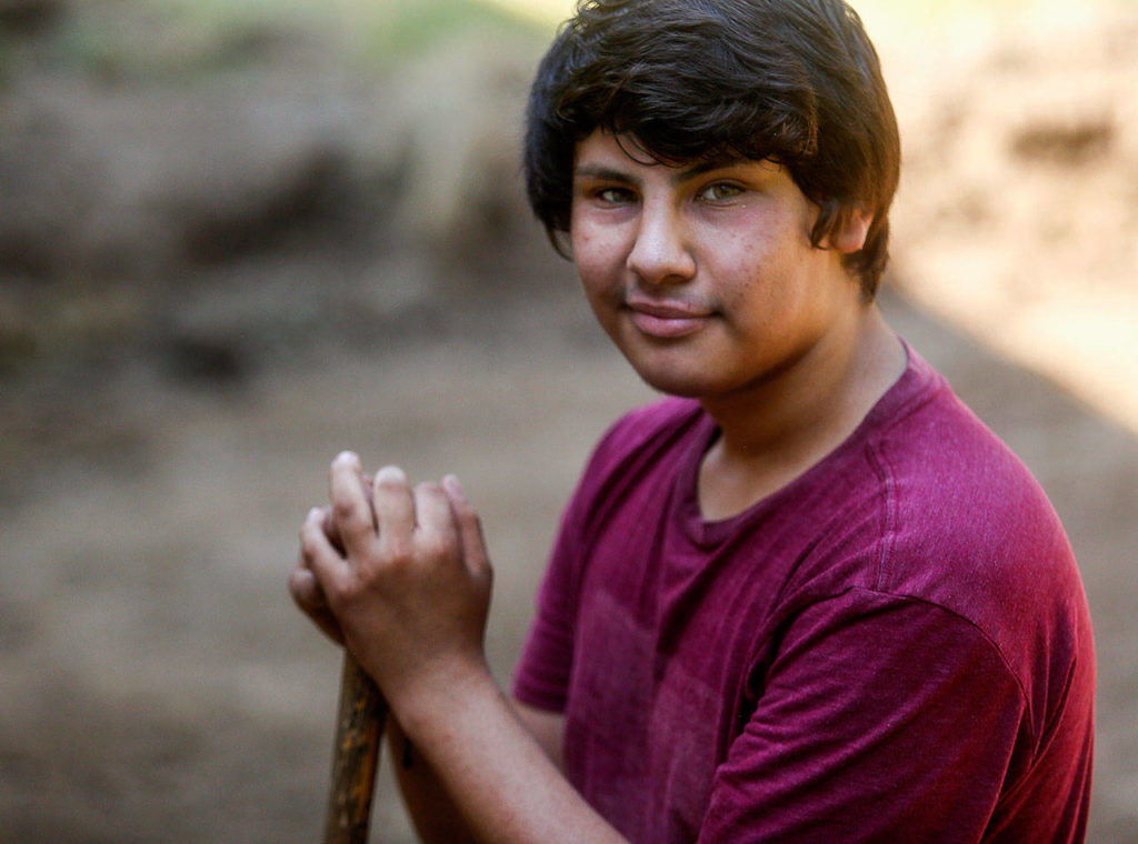 At the house being renovated for Bridge Receiving Center, Leo Fischer, 16, volunteers his time assisting construction project manager Aaron Tally. (Dan Bates / The Herald)
