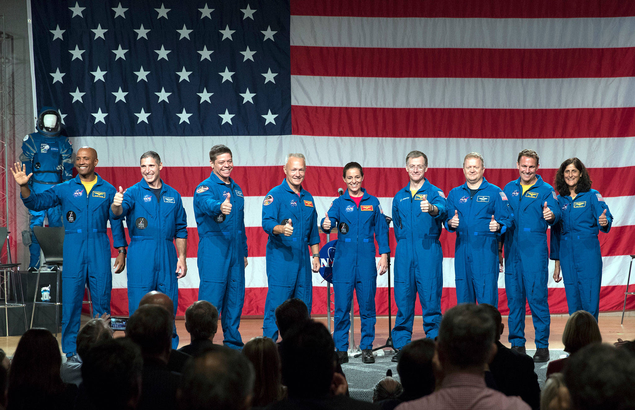 Astronauts (from left to right) Victor Glover, Michael Hopkins, Robert Behnken, Douglas Hurley, Nicole Mann, Christopher Ferguson, Eric Boe, Josh Cassada and Sunita Williams give a thumbs up to the crowd after NASA announced them as astronauts assigned to crew the first flight tests and missions of the Boeing CST-100 Starliner and SpaceX Crew Dragon. (AP Photo/David J. Phillip)