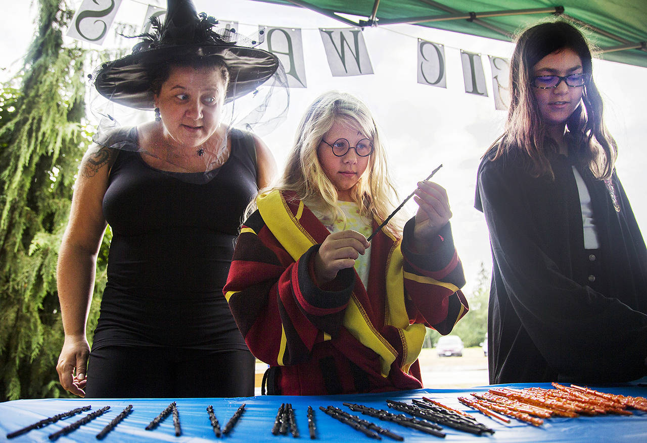 Dylynn Layman, 10, (center) chooses her wand during Hogwarts Summer School at the Granite Falls Sno-Isle Library, July 28. (Olivia Vanni / The Herald)