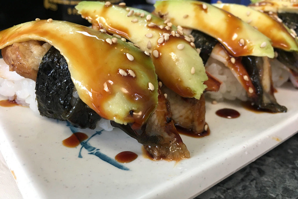 The skyscraper roll is an off-menu order of rice, shrimp, eel and avocado with a sweet eel sauce drizzled on top. (Ben Watanabe / The Herald)

