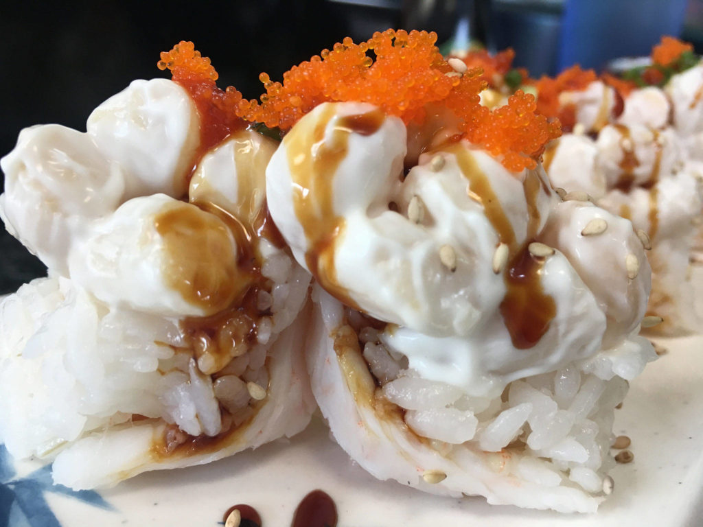 Sushi Ring’s upside down shrimp roll starts with a butterflied shrimp, then towers with rice, scallops, and flying fish roe. It’s held together by a light cream sauce for a smooth taste and texture. (Ben Watanabe / The Herald)
