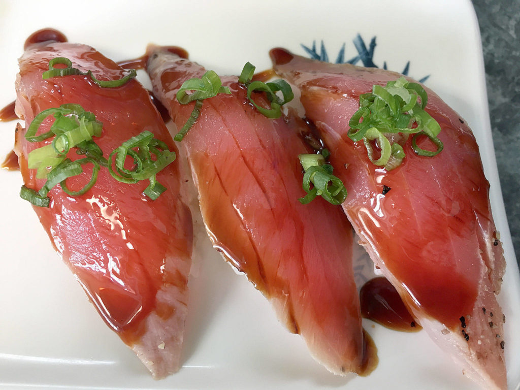 Pepper tuna with green onions and a sweet soy sauce is a flavor-balanced nigiri option at Sushi Ring in Everett. (Ben Watanabe / The Herald)
