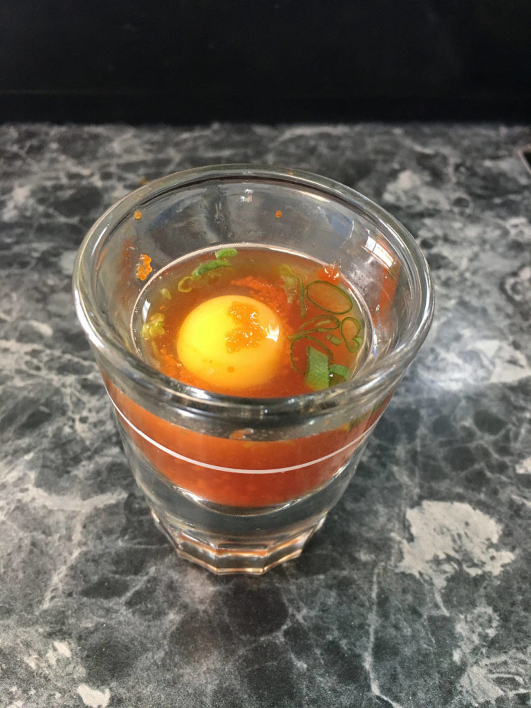 A special option at Sushi Ring in Everett is the quail egg shot with a raw quail egg dropped in ponzu sauce and garnished with fish roe and green onion. (Ben Watanabe / The Herald)
