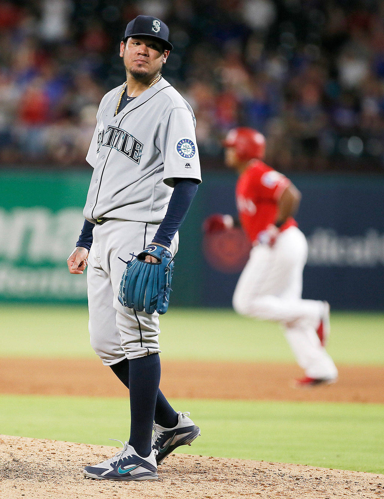 Seattle’s Felix Hernandez stands on the mound as Texas’ Adrian Beltre rounds the bases after homering off Hernandez during the sixth inning of the Mariners’ 11-4 loss to the Rangers on Tuesday in Arlington, Texas. (AP Photo/Brandon Wade)