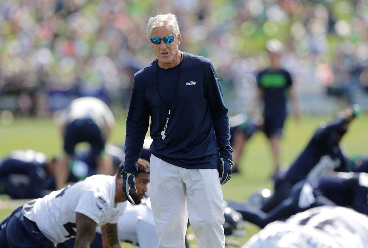 Seahawks coach Pete Carroll walks among the players during training camp on Aug. 6, 2018, in Renton. (AP Photo/Ted S. Warren)