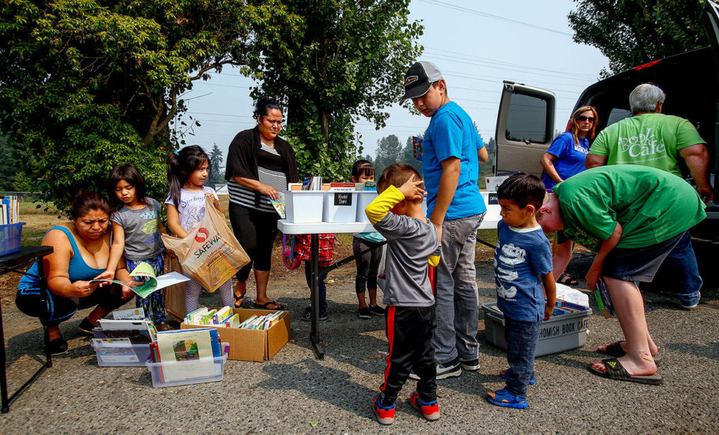 There’s a big turnout as the Book Cafe makes its Tuesday stop at the Circle H Mobile Home Park in Snohomish. (Dan Bates / The Herald)
