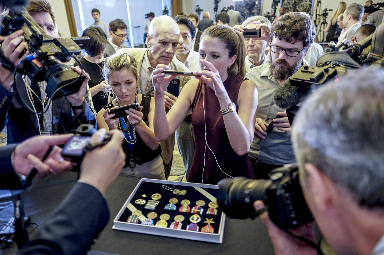 A dog tag and medals belonging to Army Master Sgt. Charles Hobert McDaniel Sr. are displayed Wednesday in Arlington, Virginia. (Bonnie Jo Mount/Washington Post)