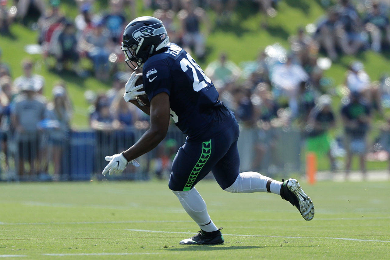 Seahawks running back Rashaad Penny runs the ball during practice on July 29, 2018, in Renton. (AP Photo/Ted S. Warren)