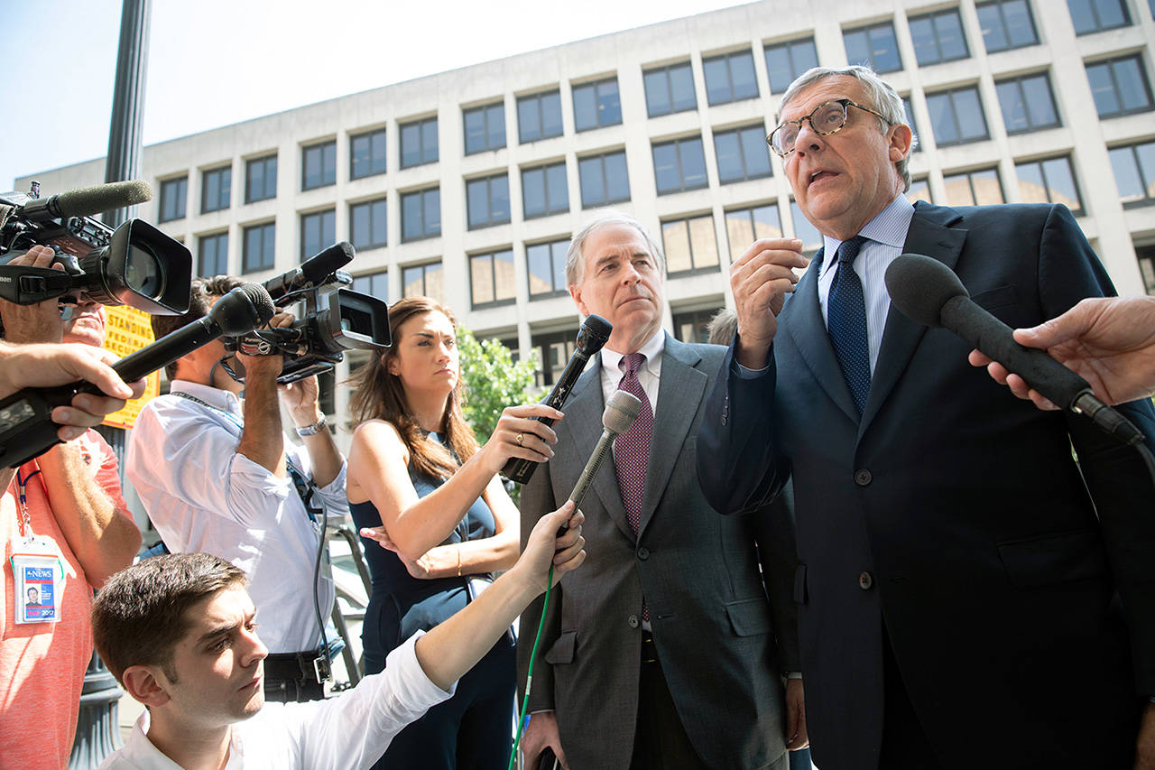 Paul Kamenar (right), attorney for Andrew Miller, is joined Friday in Washington by Peter Flaherty, chairman of the National Legal and Policy Center, to talk to reporters after a federal judge found Miller in contempt for refusing to testify before the grand jury hearing evidence in special counsel Robert Mueller’s investigation of Russian interference in the 2016 presidential election. (AP Photo/J. Scott Applewhite)