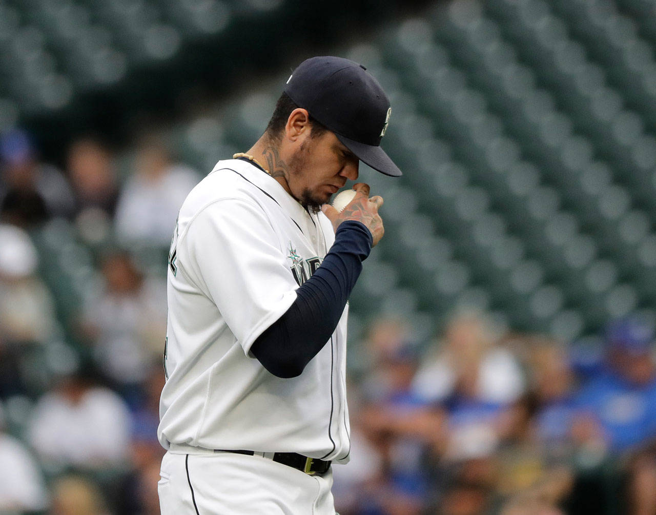 Mariners starting pitcher Felix Hernandez makes a crossing gesture while he holds the baseball as he takes the mound during a game against the Blue Jays on Aug. 2, 2018, in Seattle. (AP Photo/Ted S. Warren)