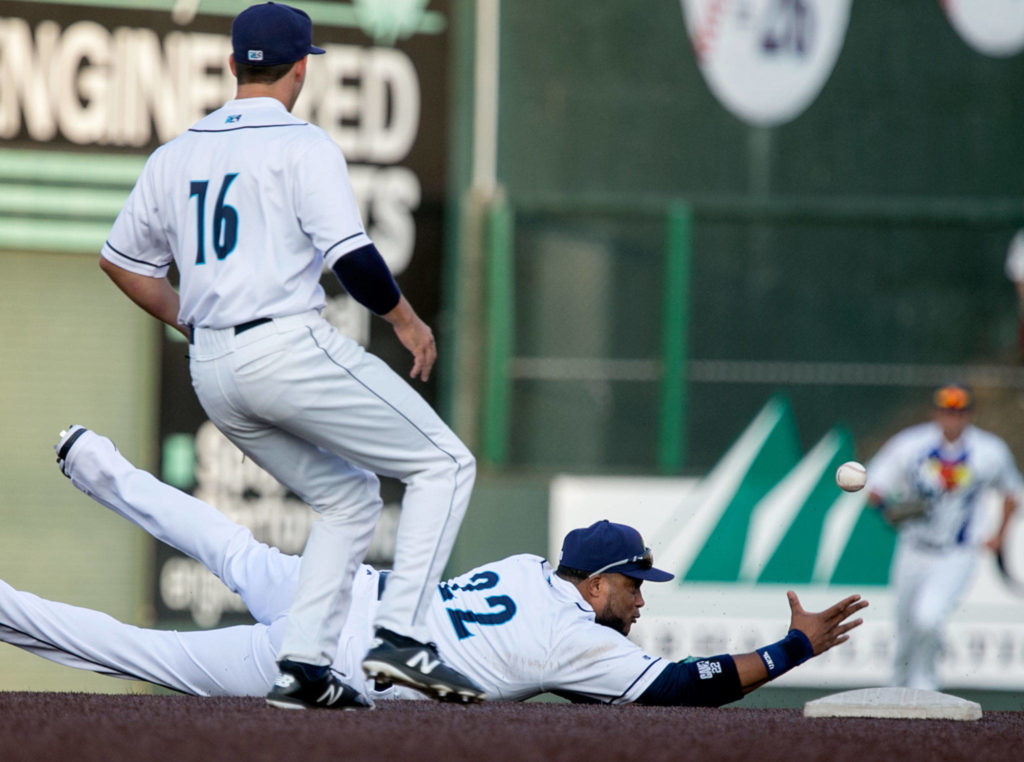 AquaSox’s Robinson Cano tosses up a fielded ground ball for teammate Ryne Ogren for a double play Friday night at Everett Memorial Stadium in Everett on Aug. 10, 2018. (Kevin Clark / The Herald)
