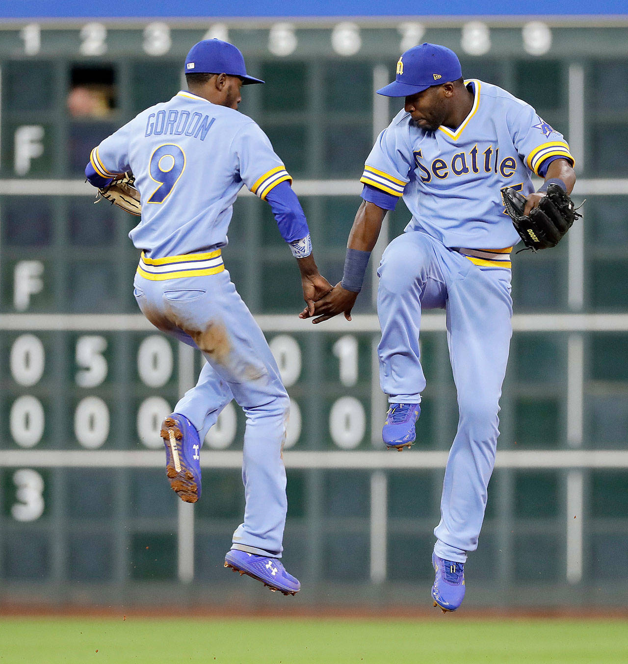 Seattle’s Dee Gordon (9) and Guillermo Heredia celebrate after the Mariners beat Houston 5-2 on Friday in Houston. (AP Photo/David J. Phillip)