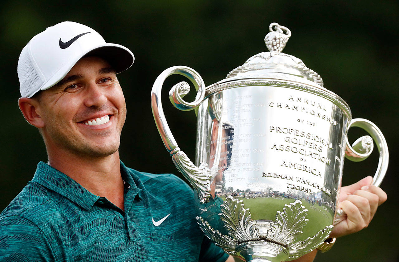 Brooks Koepka holds the Wanamaker Trophy after he won the PGA Championship on Sunday at Bellerive Country Club in St. Louis. (AP Photo/Brynn Anderson)