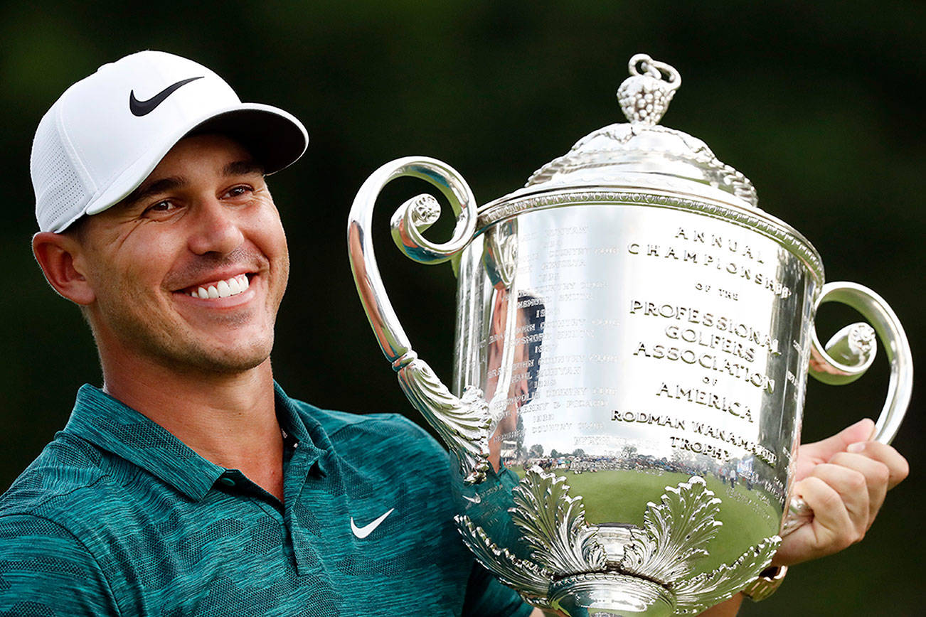 Koepka holds off Woods to win the PGA Championship