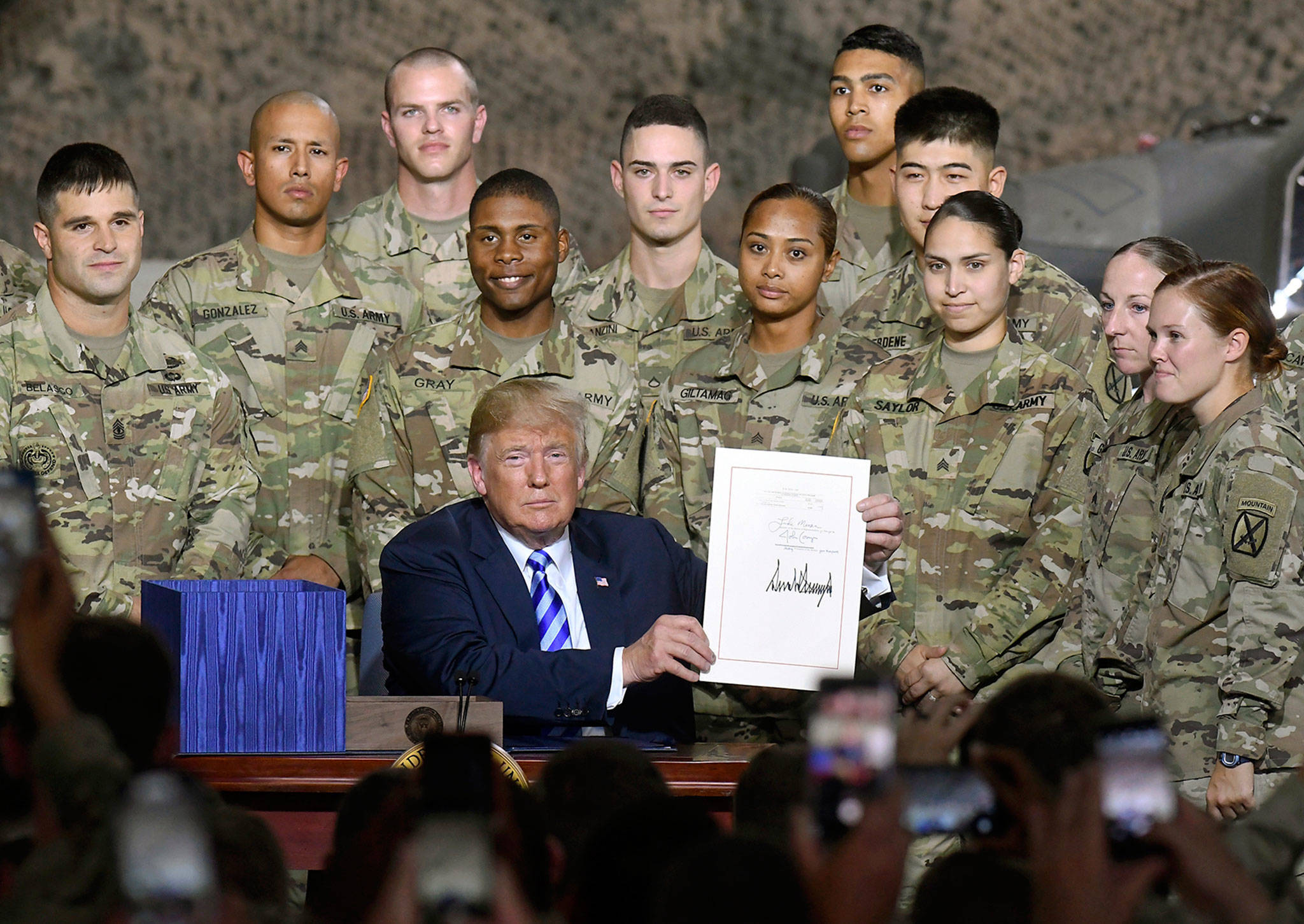 President Donald Trump signed the John McCain National Defense Authorization Act for Fiscal Year 2019 at a ceremony Monday at Fort Drum, New York. (AP Photo/Hans Pennink)