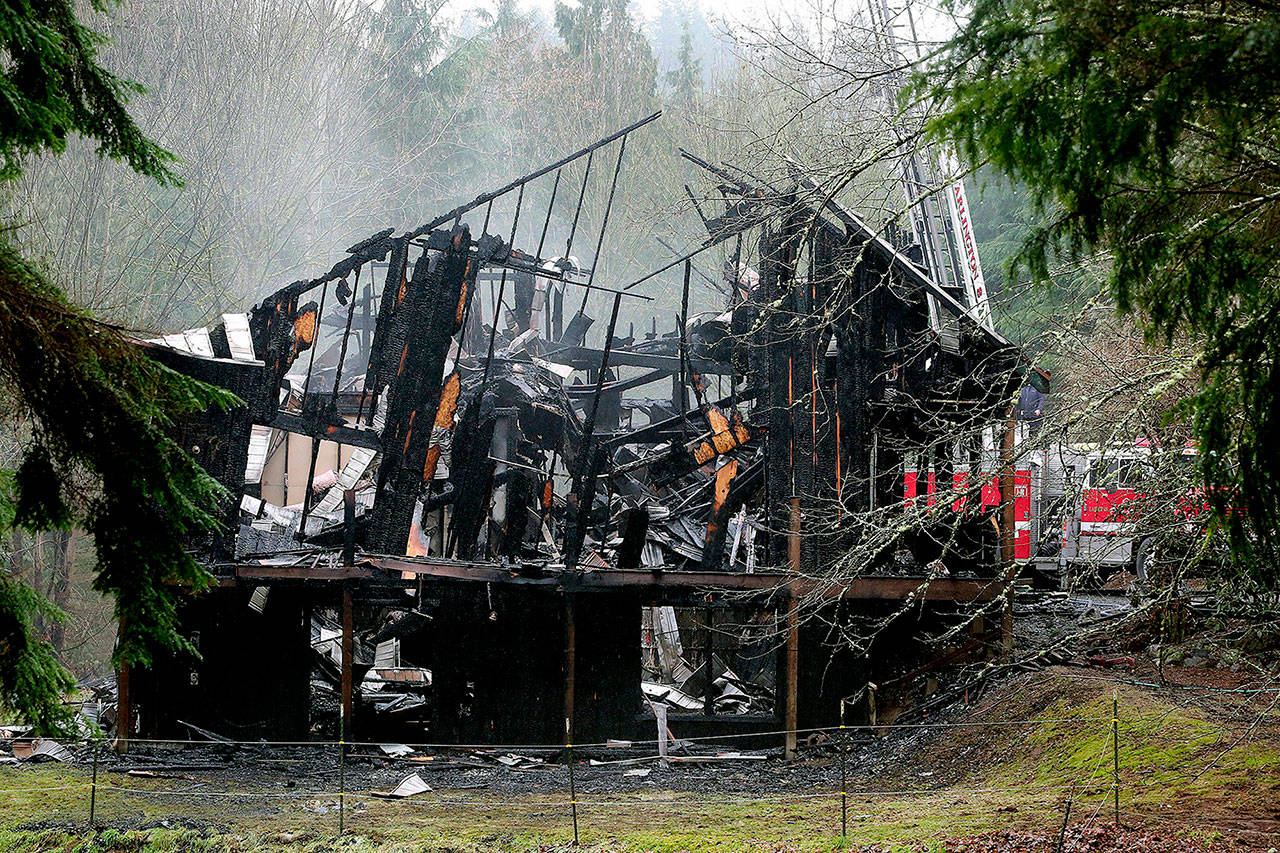 The charred remains of the Snohomish-area house where Zachary Konicke stabbed both his parents and started a fire in 2016. (Greg Gilbert / Seattle Times via AP)