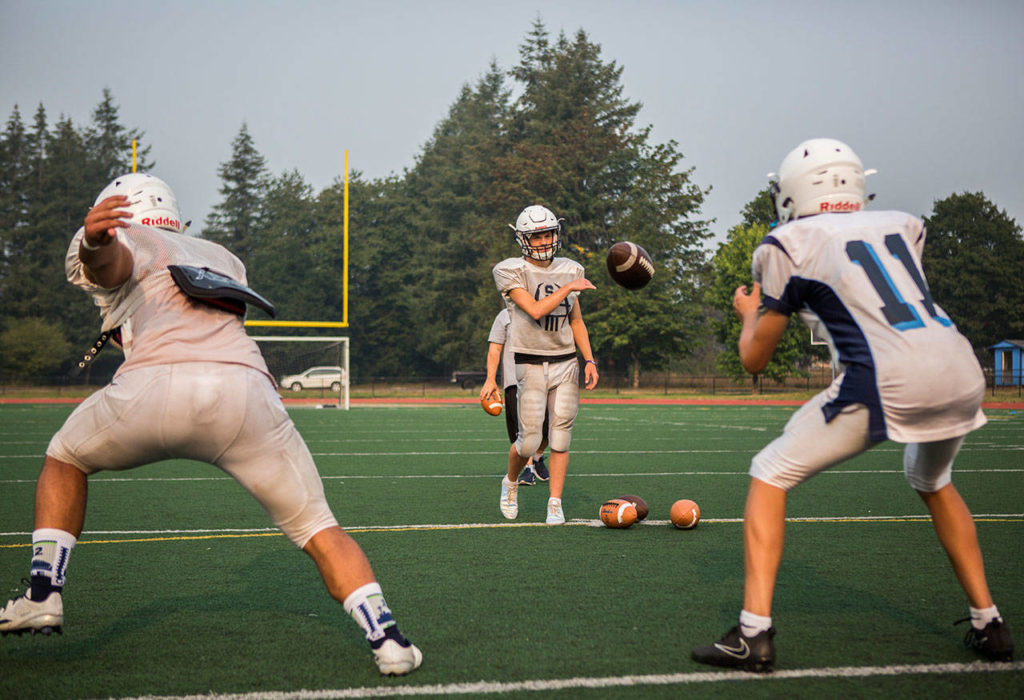 Players run through drills during Sultan High School’s Aug. 22 football practice. (Olivia Vanni / The Herald)
