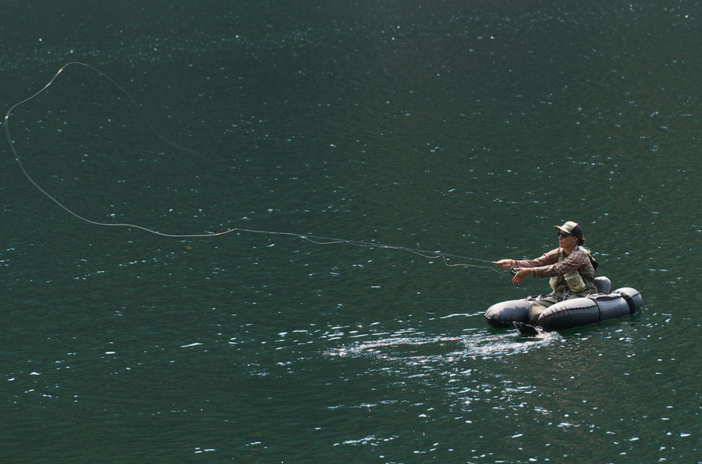 Anna Oenbring of Granite Falls casts a fly into the clear waters of Slide Lake. (Mike Benbow photo)
