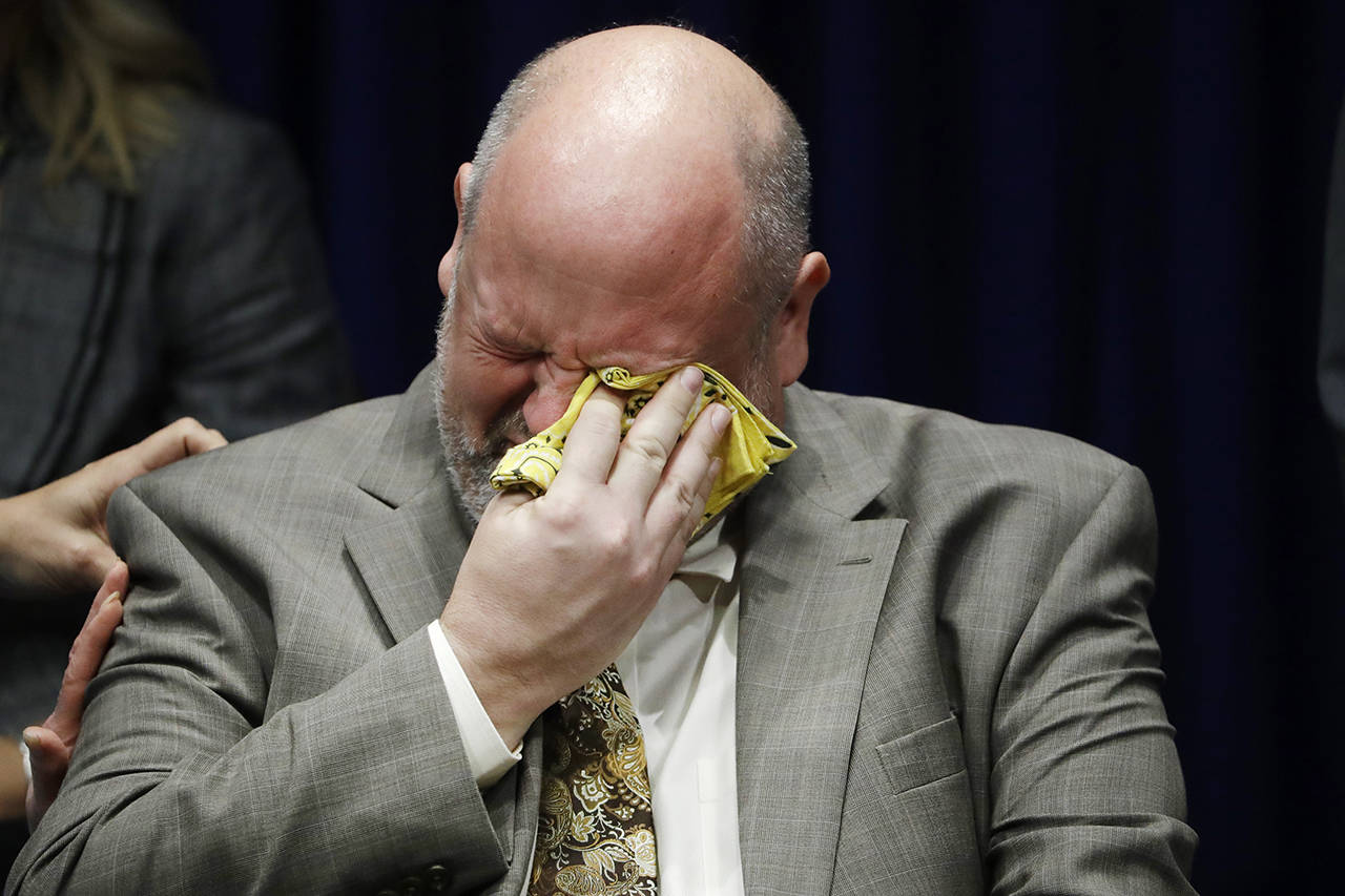 Former priest James Faluszczak, who says he was molested by a priest as a teenager, reacts as Pennsylvania Attorney General Josh Shapiro speaks during a news conference at the Pennsylvania Capitol in Harrisburg, Pennsylvania, on Tuesday, Aug. 14. (AP Photo/Matt Rourke)