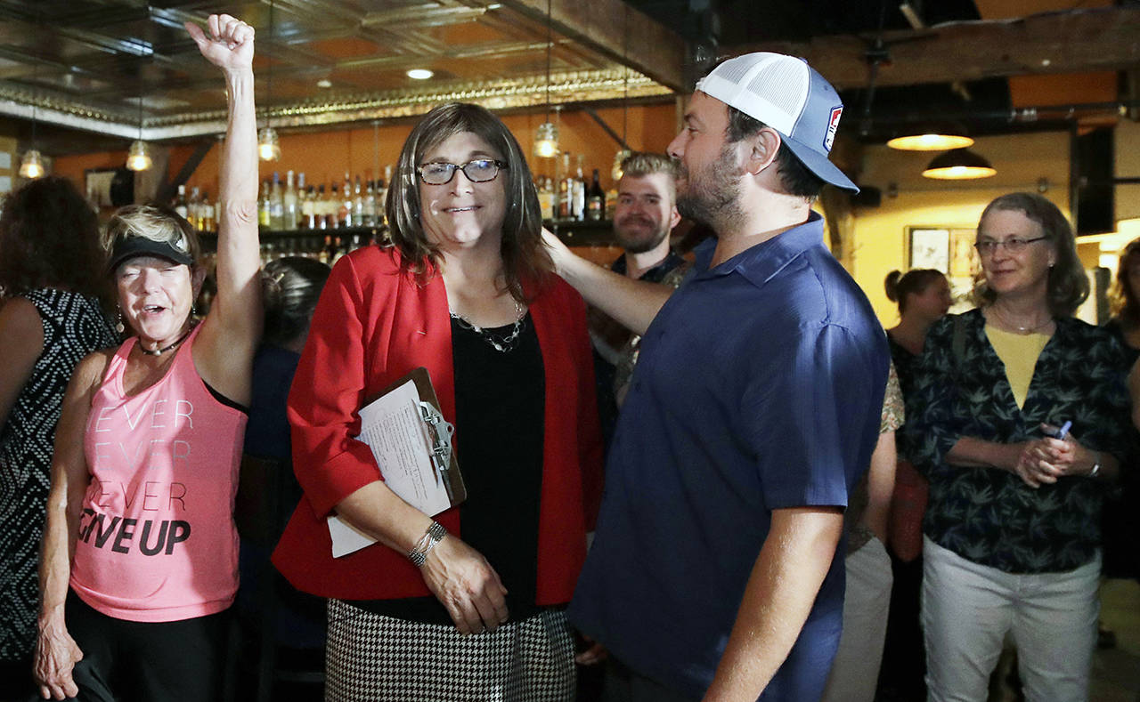 Vermont Democratic gubernatorial candidate Christine Hallquist (center), a transgender woman and former utility executive, is greeted by her supporters during her election night party in Burlington, Vermont, on Tuesday, Aug. 14. (AP Photo/Charles Krupa)