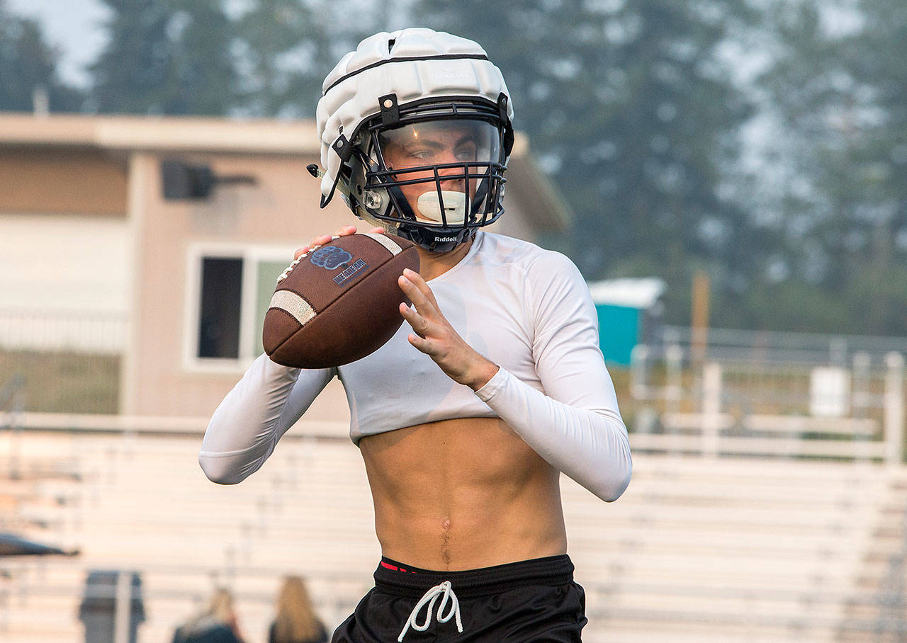 Glacier Peak’s quarterback Ayden Ziomas prepares to throw the ball during football practice at Glacier Peak High School on Aug. 15, 2018 in Snohomish, Wa. (Olivia Vanni / The Herald)