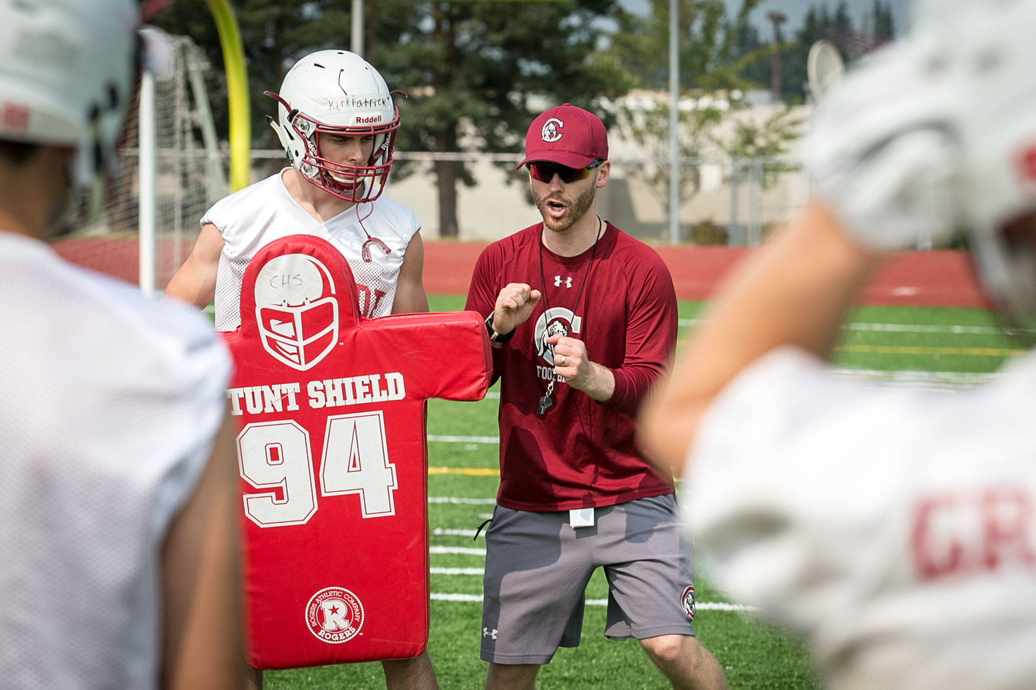 Cascade football coach Jordan Sieh explains a play during a Thursday practice session at Cascade High School. (Kevin Clark / The Herald)