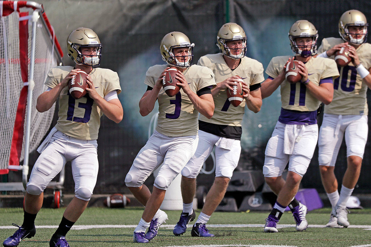 Young Huskies quarterbacks learning on the job