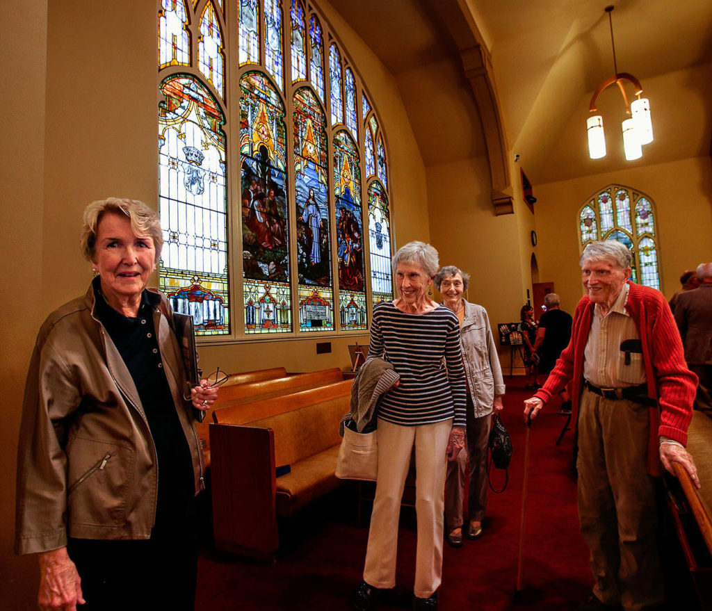 Elizabeth Moody Campbell (left), Jackie Minor, Maggie Lamus and Dr. Hugh Minor (right) prepare to leave after enjoying an up-close study of the stained glass windows in First Presbyterian Church during the Everett Art Walk on Thursday. Campell’s grandfather, Everett Pulp and Paper Co. President William Howarth, funded the church’s largest window (back), created in 1910. (Dan Bates / The Herald)
