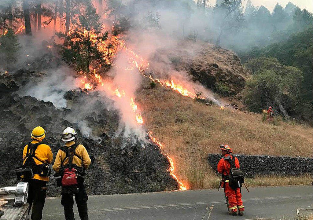 Firefighters monitor flames at a California wildfire. (Photo courtesy of Ernie Walters)
