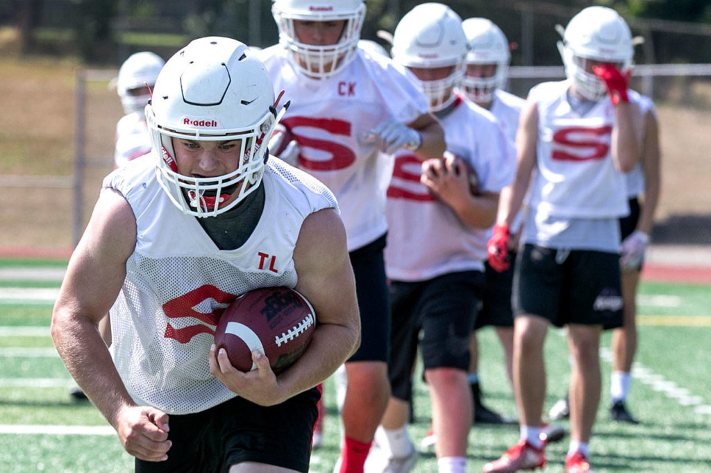 Tyler Larson runs through drills during practice Friday afternoon at Veterans Memorial Stadium in Snohomish. (Kevin Clark / The Herald)
