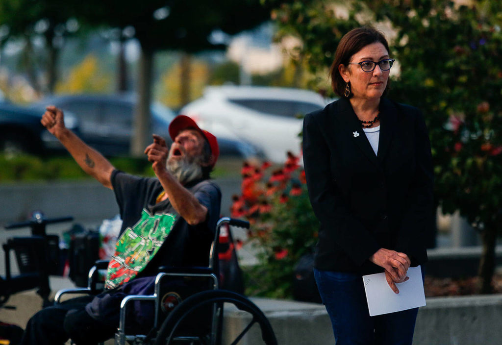 Congresswoman Suzan DelBene waits for Snohomish County Executive Dave Somers to finish speaking Thursday evening before taking her turn. (Dan Bates / The Herald)
