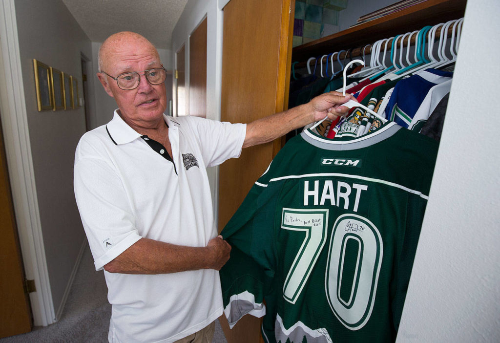 Parker Fowlds holds up a Carter Hart jersey from a closet in his Mukilteo home on Aug. 17. Hart is one of 15 players who have been billeted at Fowlds’ home over the life of the franchise. (Andy Bronson / The Herald)
