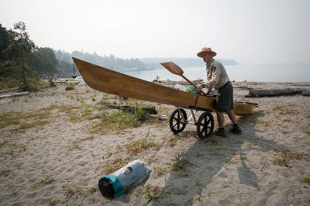 Doug Dailer, a ranger at Meadowdale Beach Park in Edmonds, likes to greet kayakers as they approach the campsite on his paddle board. (Lizz Giordano / The Herald)
