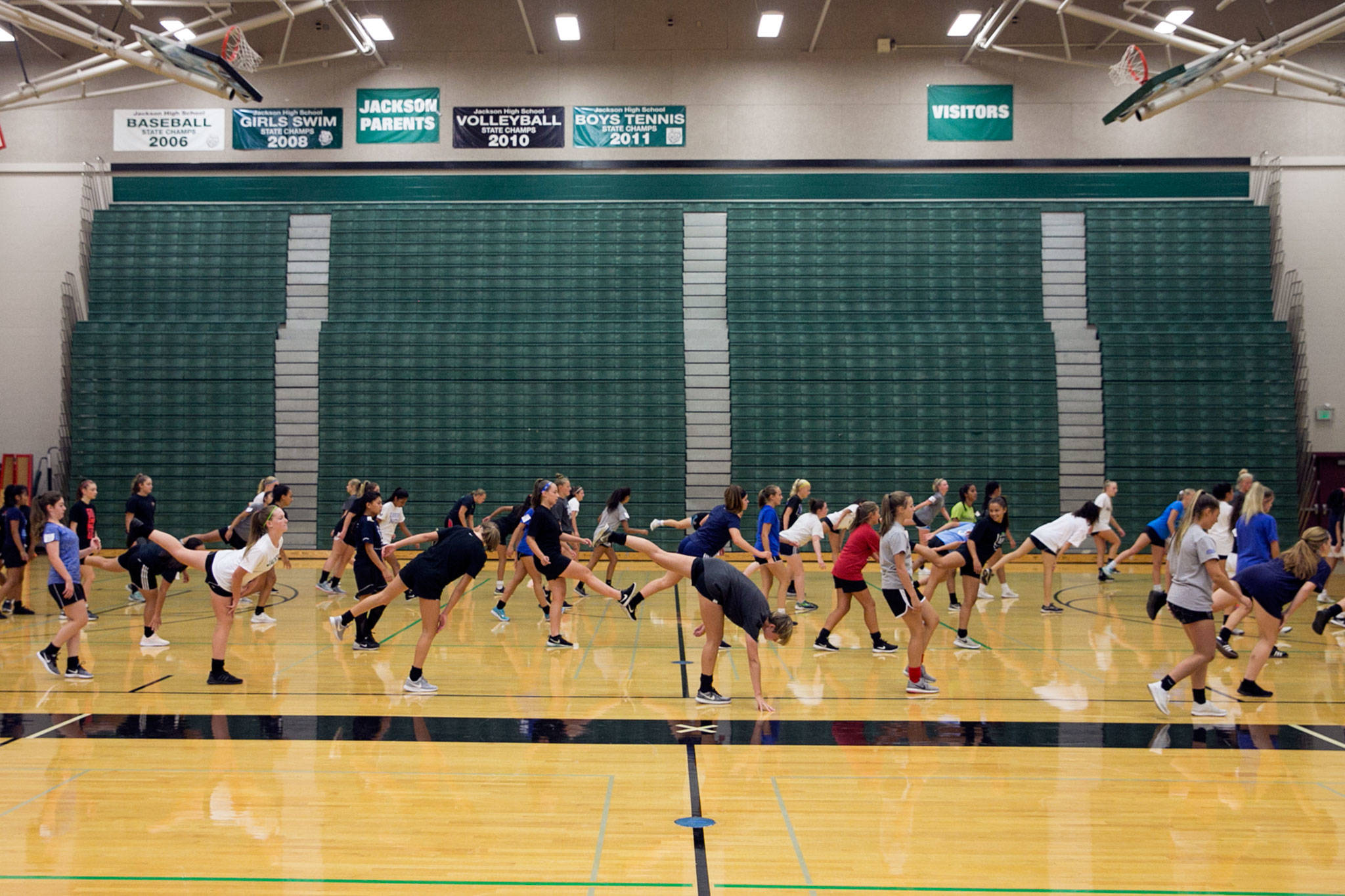 Jackson High School soccer hopefuls stretch before scrimmages in the school gym due to poor air quality in Mill Creek on August 21, 2018. (Kevin Clark / The Herald)