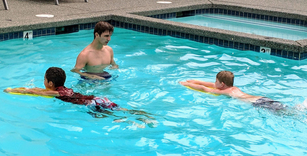 Kids who live in the Casino Road area of Everett were able to get free swim lessons from YMCA instructors, including Johnny Reed, during a weeklong program held at the Crystal Spring apartment complex pool. (Contributed photo)
