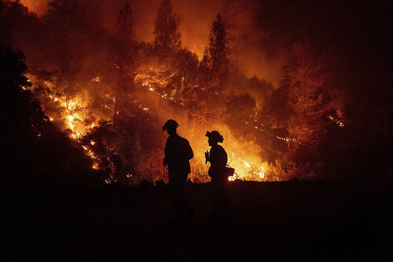 Firefighters monitor a backfire while battling the Ranch Fire, part of the Mendocino Complex Fire, on Aug. 7, near Ladoga, California. (AP Photo/Noah Berger, file)
