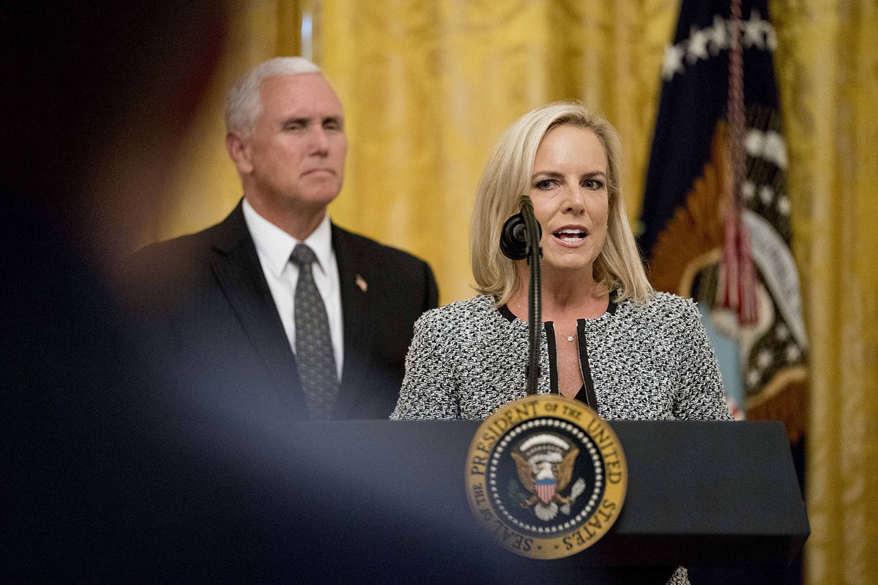 Homeland Security Secretary Kirstjen Nielsen (right), accompanied by Vice President Mike Pence (left), speaks during an event to salute U.S. Immigration and Customs Enforcement (ICE) officers and U.S. Customs and Border Protection (CBP) agents in the East Room of the White House in Washington on Monday, Aug. 20. (AP Photo/Andrew Harnik)