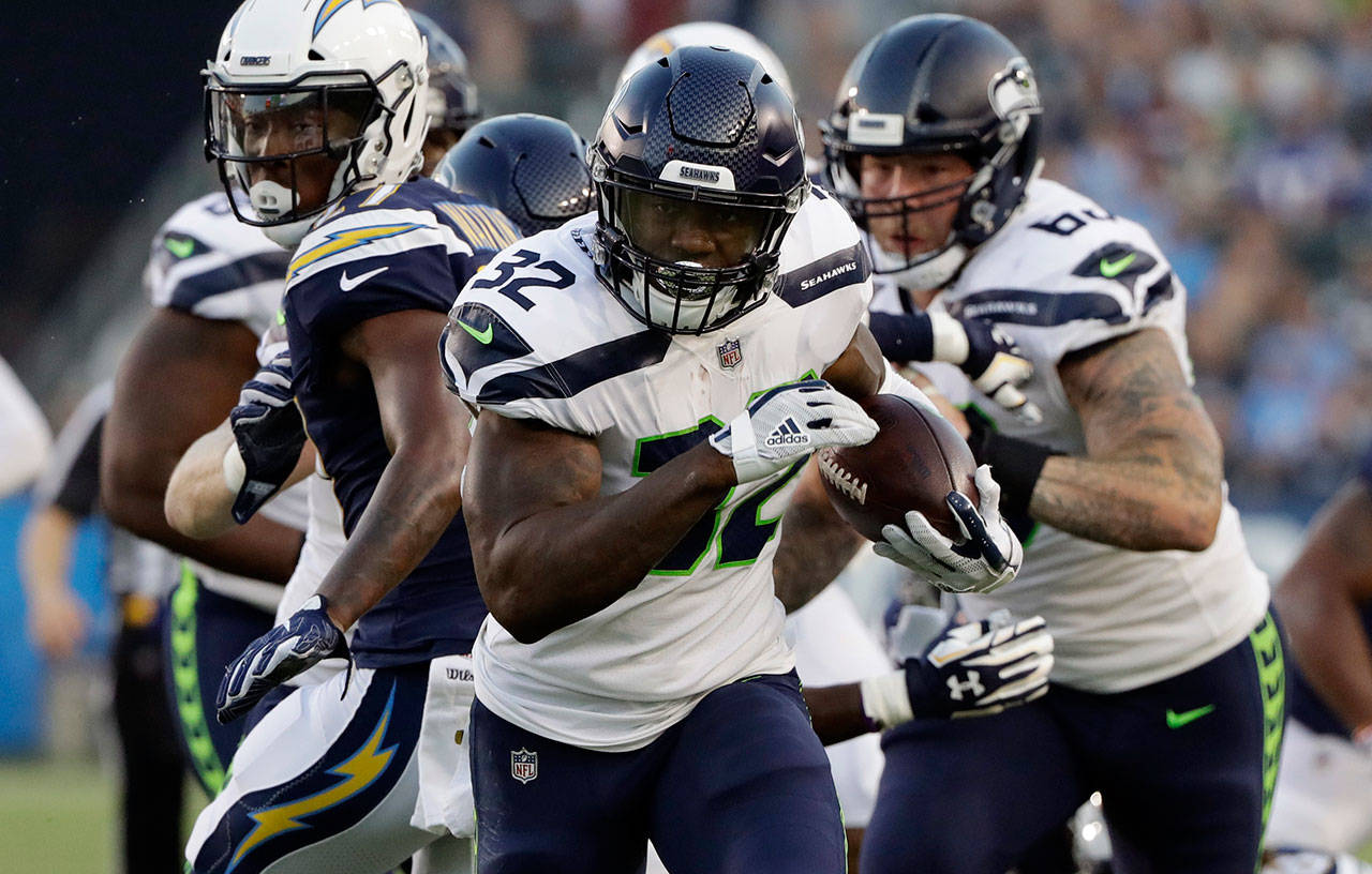 Seahawks running back Chris Carson (32) runs against the Chargers during the first half of a preseason game on Aug. 18, 2018, in Carson, Calif. (AP Photo/Gregory Bull)