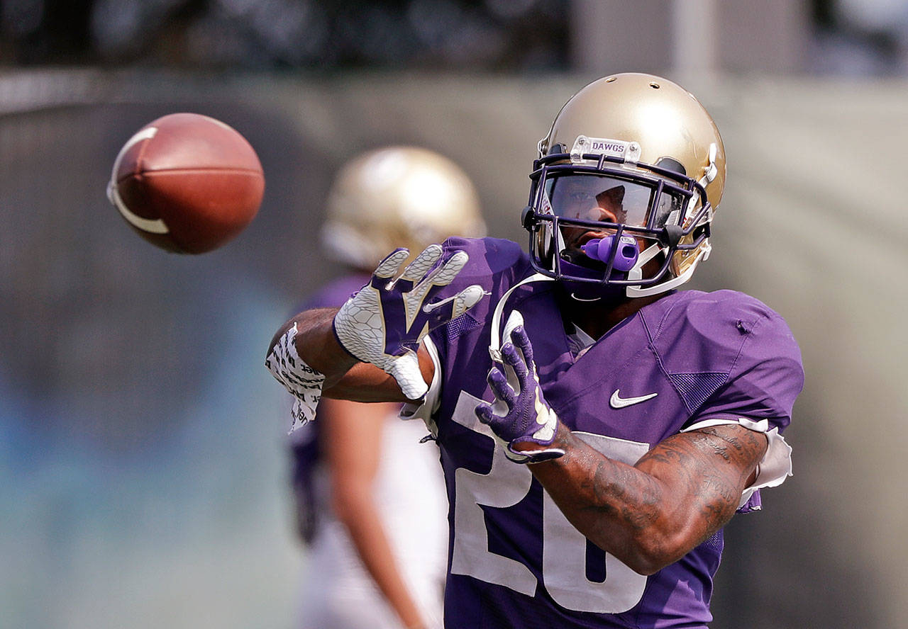 Washington running back Salvon Ahmed reaches for the ball during practice on Aug. 10, 2018, in Seattle. (AP Photo/Elaine Thompson)