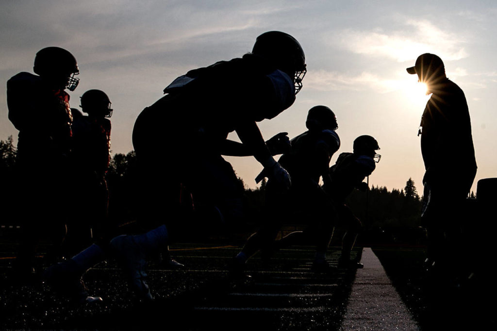 Lakewood players run through offensive line drills during practice on Aug. 23, 2018, at Lakewood High School in Arlington. (Kevin Clark / The Herald)
