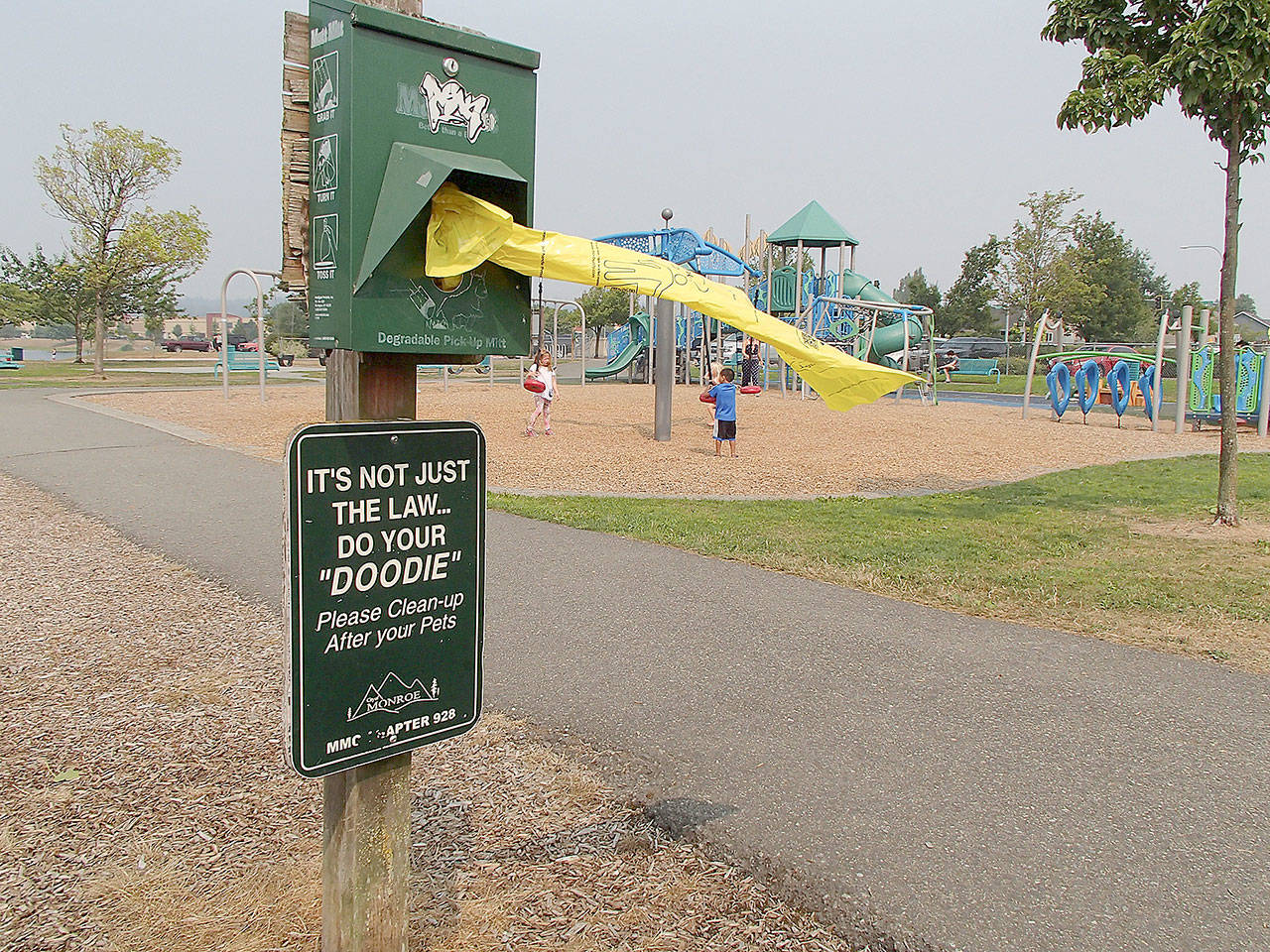 A sign at Lake Tye Park in Monroe reminds pet owners to do their “doodie” — er, duty — and clean up their pet’s waste. The city even offers free bags to help scoop the poop. You may still have to watch your step. The law does not cover the droppings of myriad goose and duck visitors who, after all, are no one’s pet. (Herald photo)