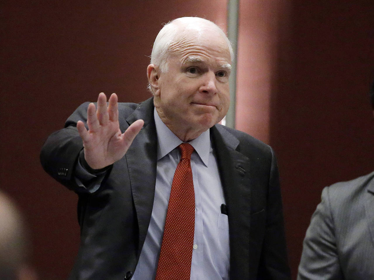 In this June 3, 2016, photo, Sen. John McCain greets the audience as he arrives to deliver a speech in Singapore. McCain, the war hero who became the GOP’s standard-bearer in the 2008 election, died Saturday, Aug. 25, 2018. He was 81. (AP Photo/Wong Maye-E, File)