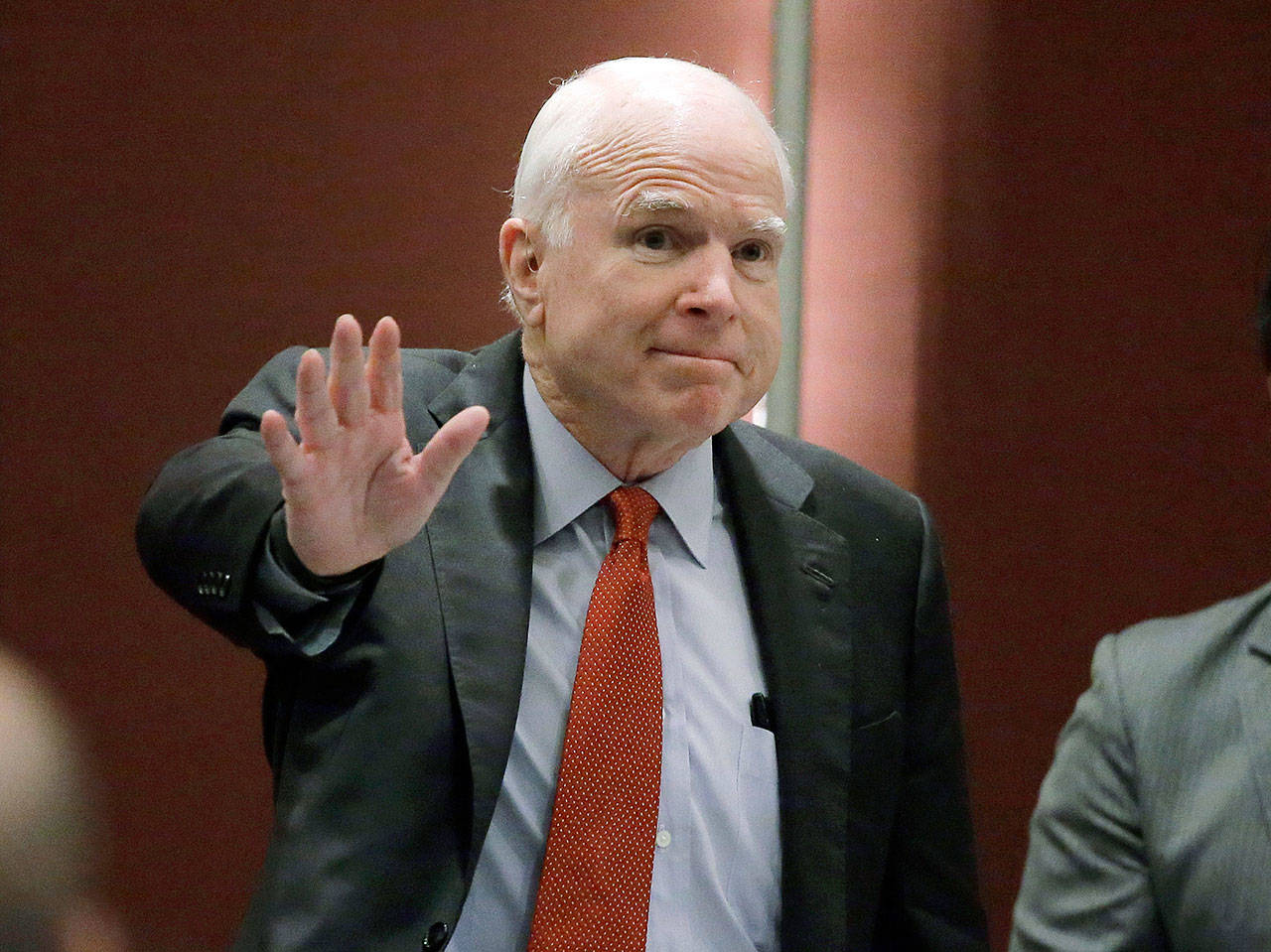 Sen. John McCain, R-Ariz., greets the audience as he arrives to deliver a speech June 3, 2016, in Singapore. McCain, the war hero who became the GOP’s standard-bearer in the 2008 election, died Saturday. He was 81. (AP Photo/Wong Maye-E, File)