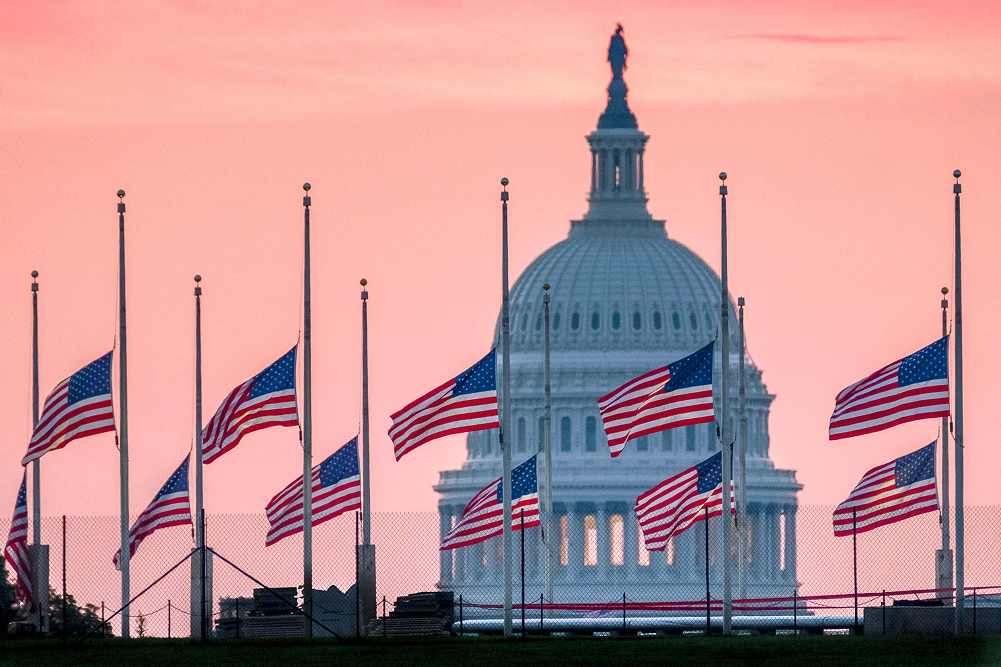 Flags flying at half-staff in honor of Sen. John McCain, R-Arizona, at the U.S. Capital at daybreak in Washington on Sunday. (AP Photo/J. David Ake)