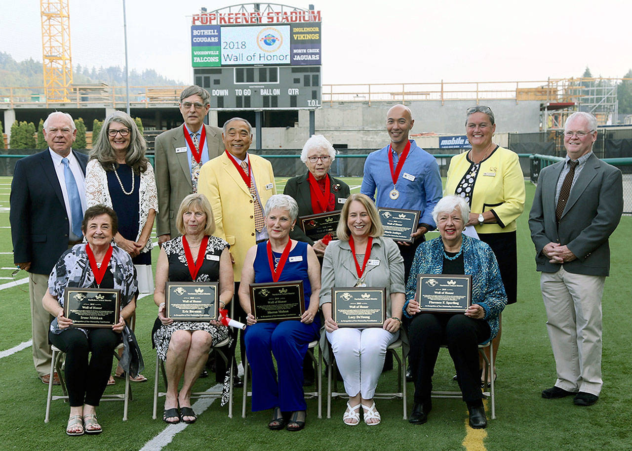 Nine Northshore School District alumni, former staff and volunteers were recognized Aug. 16 at a 2018 Wall of Honor ceremony at Pop Keeney Stadium. Standing, from left: Wall of Honor executive board members Alan Strand and Vicki Metz, honorees Stephen Mladineo, Dwight Funai, Laurel Petersen James and Mario Andaya, Superintendent Michelle Reid, Wall of Honor executive board member Mace Brady. Seated: honoree Irene Millikan, Sally Barnum on behalf of the late Eric Barnum, honorees Sheron Mohan and Lucy DeYoung, and Garrell Sperling Lindberg on behalf of Florence Smith Sperling. (Contributed photo)