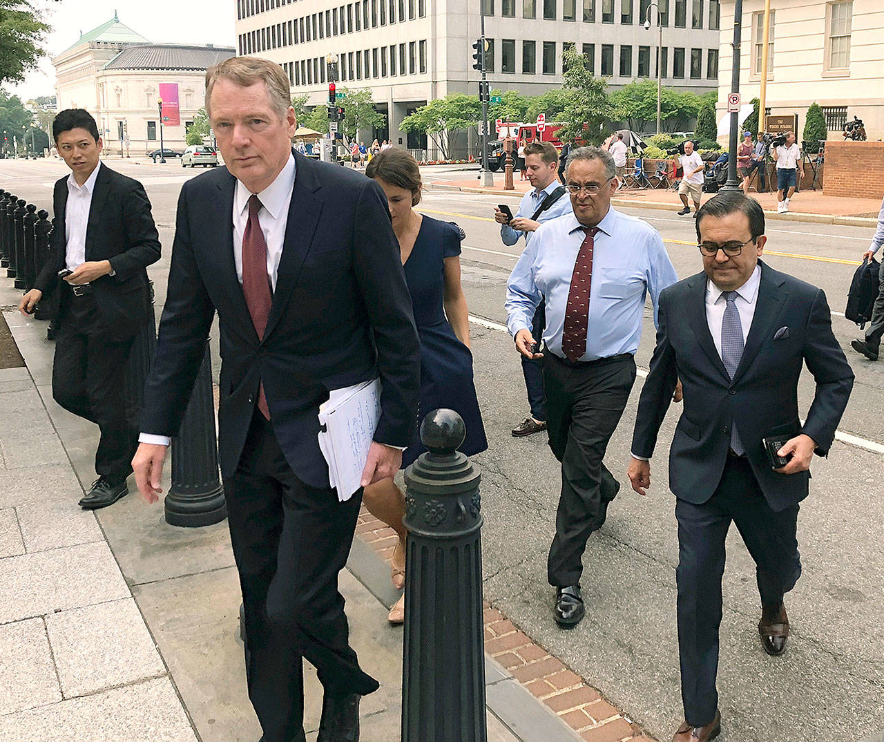 U.S. Trade Representative Robert Lighthizer (front left) and Mexican Secretary of Economy Idelfonso Guajardo (front right) walk to the White House on Monday. (AP Photo/Luis Alonso Lugo)